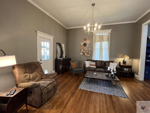 living room featuring dark hardwood / wood-style floors, ornamental molding, and an inviting chandelier