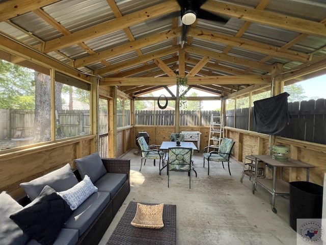 sunroom featuring ceiling fan and vaulted ceiling