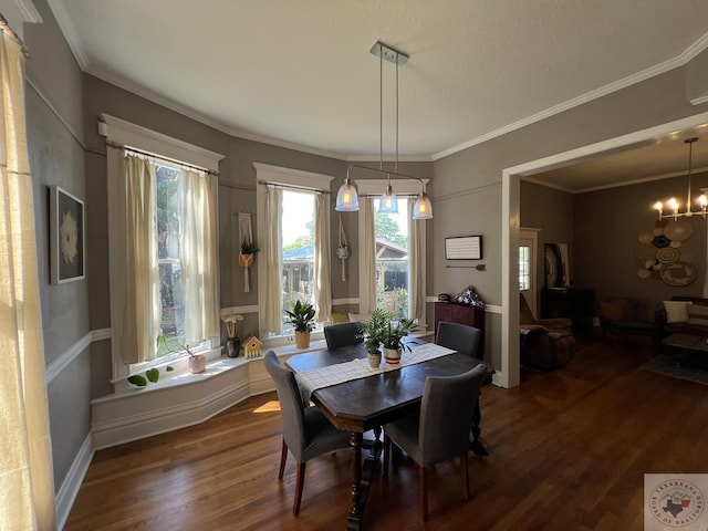 dining space featuring a notable chandelier, crown molding, and dark hardwood / wood-style flooring