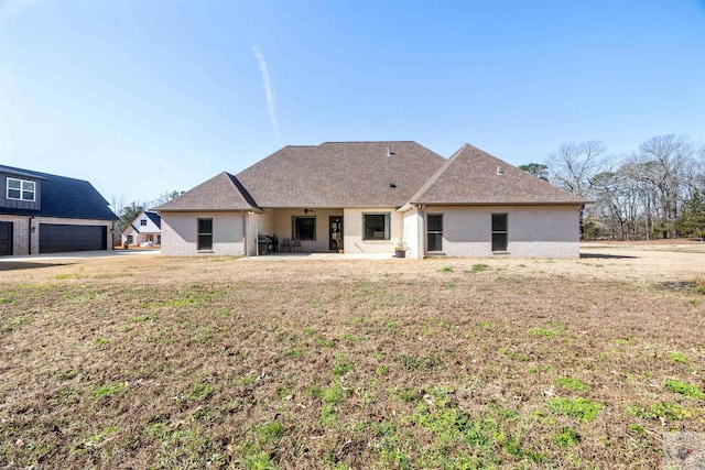 rear view of house featuring a patio area and a yard