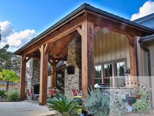 view of side of property featuring a fireplace and a patio