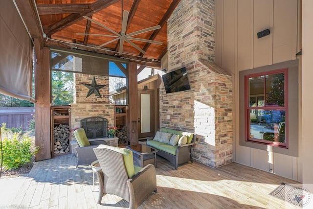 view of patio featuring a wooden deck, an outdoor living space with a fireplace, and ceiling fan