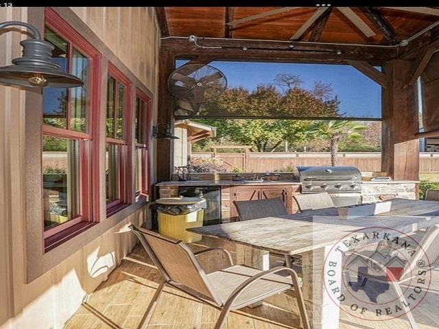 view of patio / terrace featuring exterior kitchen, an outdoor bar, and grilling area