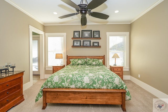 carpeted bedroom featuring ceiling fan and crown molding