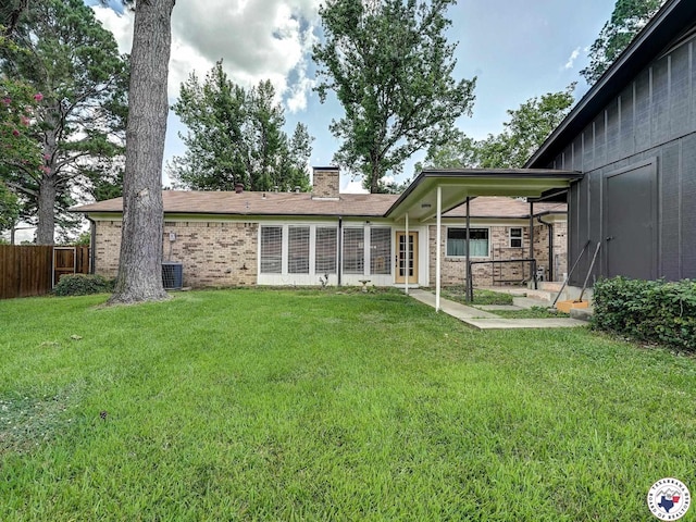 1216 Lavaca Ave, Texarkana, TX 75503 - back of property featuring a chimney, a patio, and brick siding