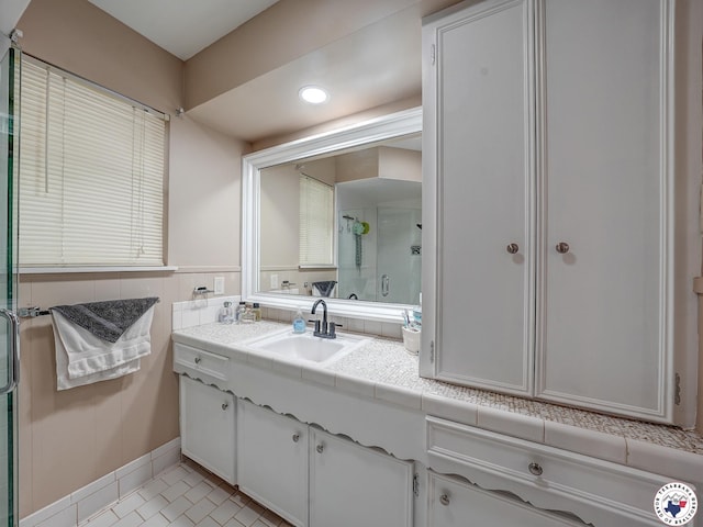 1216 Lavaca Ave, Texarkana, TX 75503 - full bathroom featuring vanity, a shower stall, recessed lighting, and a wainscoted wall