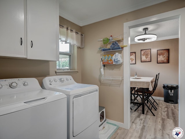 1216 Lavaca Ave, Texarkana, TX 75503 - washroom featuring washing machine and clothes dryer, cabinet space, crown molding, and light wood-type flooring