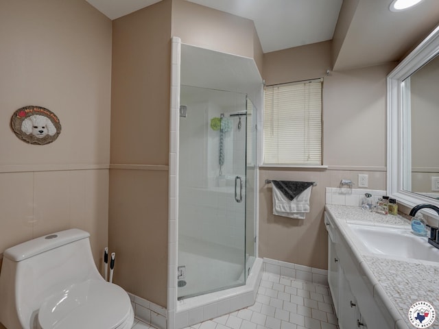 1216 Lavaca Ave, Texarkana, TX 75503 - bathroom featuring vanity, a stall shower, tile patterned flooring, and wainscoting