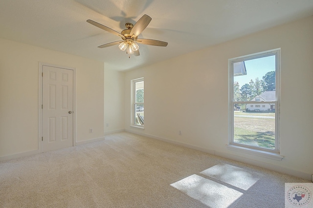 unfurnished room featuring light colored carpet and ceiling fan