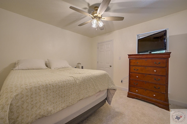 bedroom with ceiling fan and light carpet