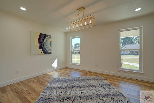 empty room with light hardwood / wood-style flooring