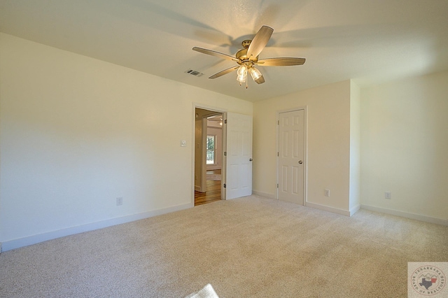 carpeted empty room with ceiling fan