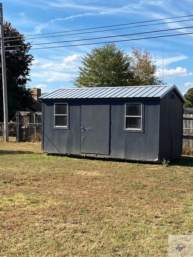 view of outbuilding with a yard