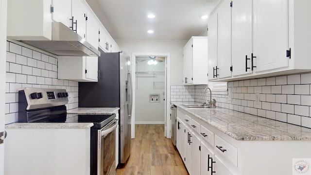 kitchen featuring light hardwood / wood-style flooring, ceiling fan, appliances with stainless steel finishes, sink, and white cabinetry