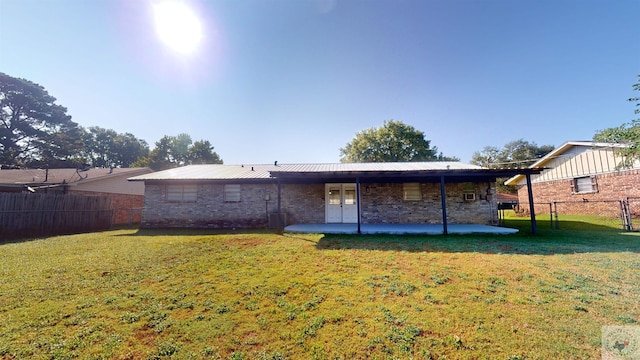 back of property featuring a patio area and a yard