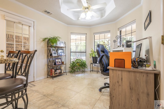 home office featuring plenty of natural light, a textured ceiling, light tile patterned floors, and a tray ceiling