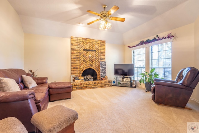 living room featuring lofted ceiling, carpet flooring, a brick fireplace, and ceiling fan