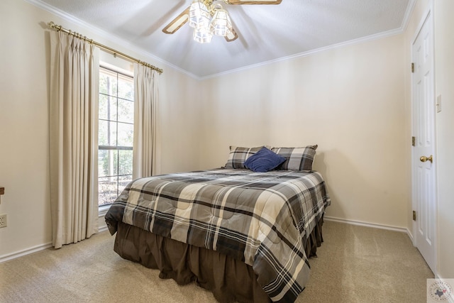 bedroom featuring ceiling fan, crown molding, and light carpet