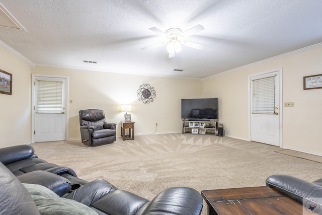 carpeted living room featuring crown molding, a textured ceiling, and ceiling fan