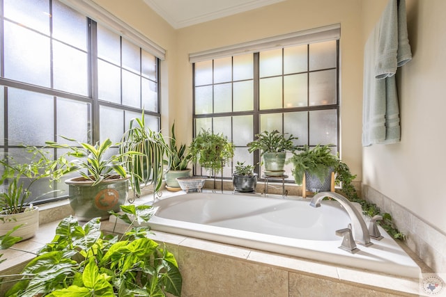 bathroom with crown molding and tiled tub