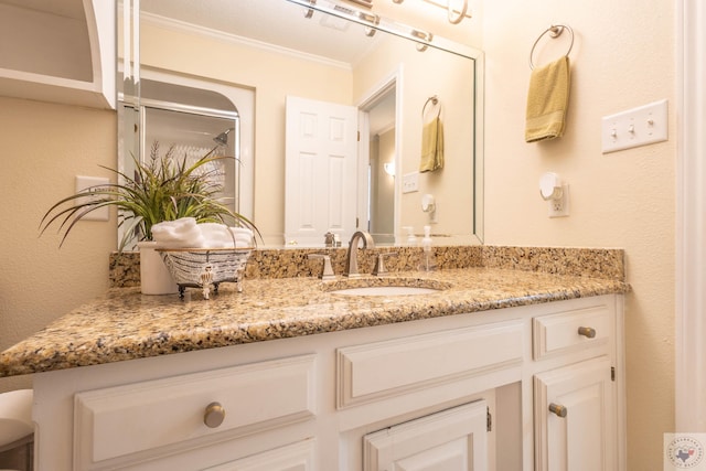 bathroom featuring ornamental molding and vanity