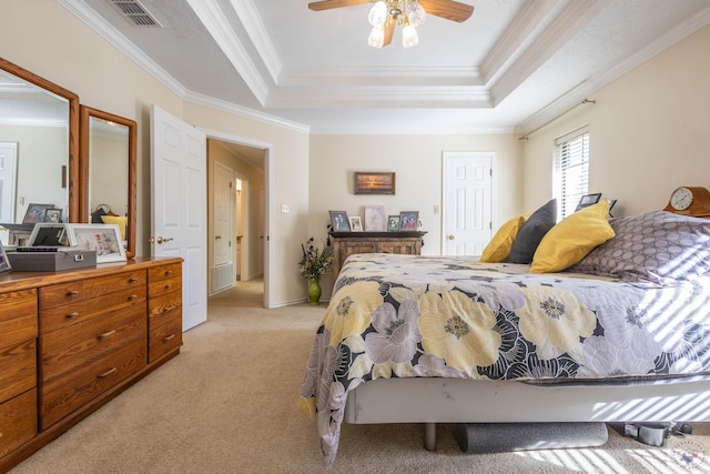 bedroom with ceiling fan, light colored carpet, crown molding, and a raised ceiling