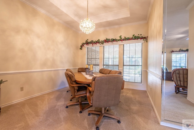 dining space with a chandelier, carpet, crown molding, and a tray ceiling