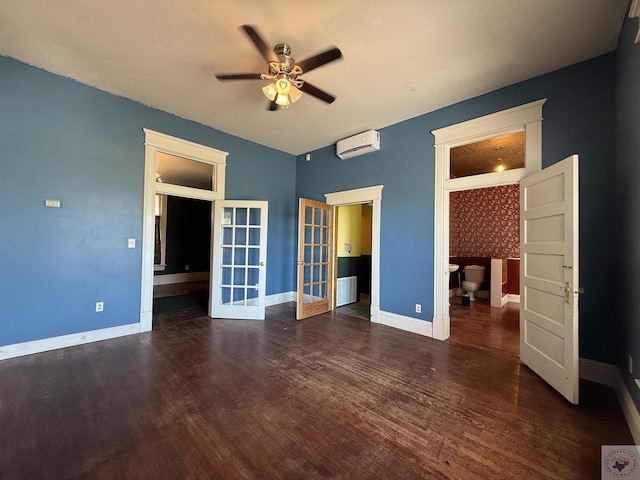 unfurnished bedroom featuring a wall unit AC, wood finished floors, french doors, and baseboards