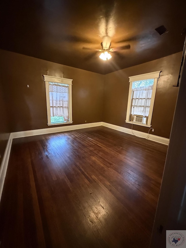 spare room featuring ceiling fan, plenty of natural light, and wood-type flooring