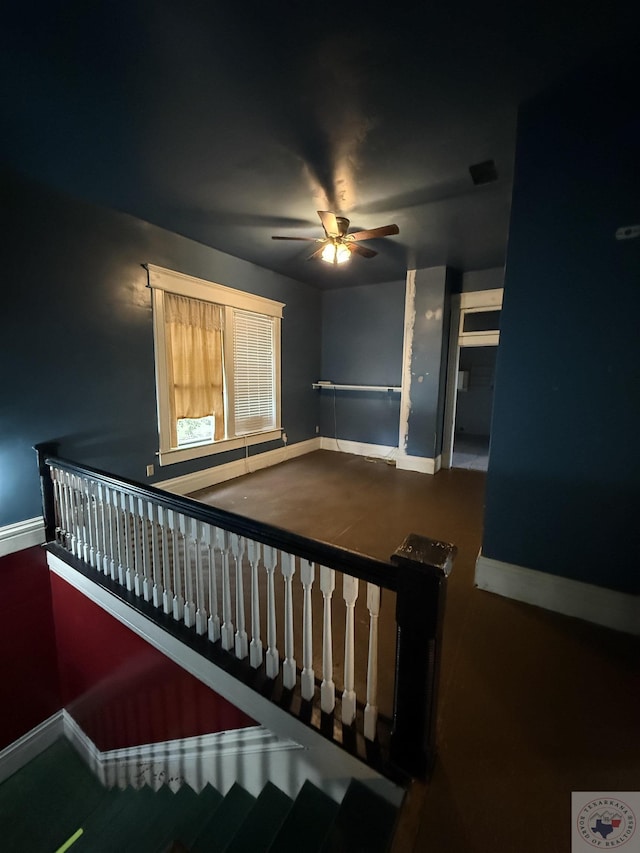 stairs featuring baseboards, visible vents, and ceiling fan