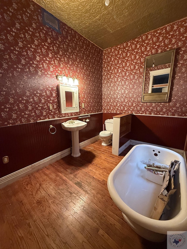 bathroom featuring sink, hardwood / wood-style flooring, and toilet