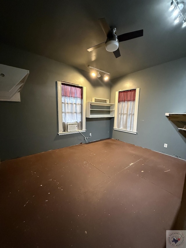 unfurnished living room featuring ceiling fan, rail lighting, cooling unit, and a healthy amount of sunlight