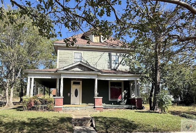 view of front of property with a porch and a front yard