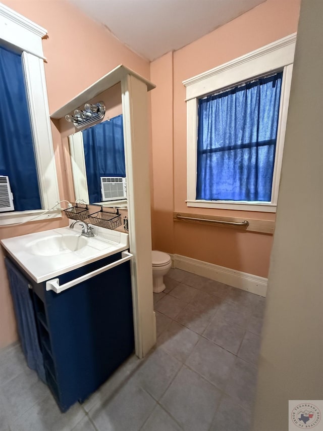 bathroom with toilet, cooling unit, tile patterned floors, and vanity