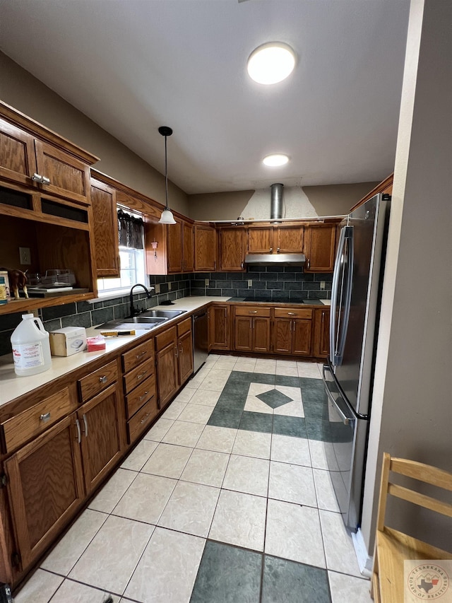 kitchen featuring dishwasher, stainless steel fridge, hanging light fixtures, sink, and light tile patterned floors