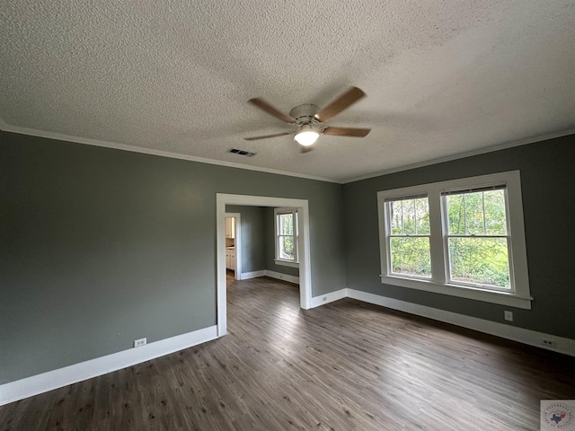 unfurnished room featuring ornamental molding, a textured ceiling, and wood-type flooring