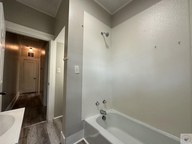 bathroom with hardwood / wood-style flooring, a textured ceiling, vanity, and  shower combination