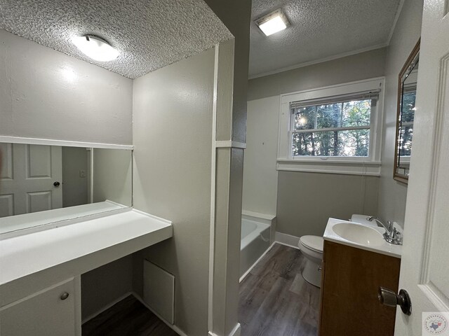 bathroom featuring hardwood / wood-style flooring, a textured ceiling, toilet, and vanity