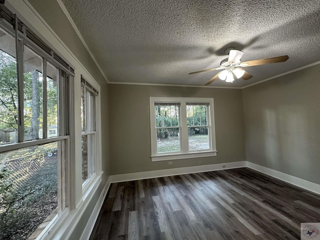 unfurnished room with ornamental molding, a wealth of natural light, and dark hardwood / wood-style flooring