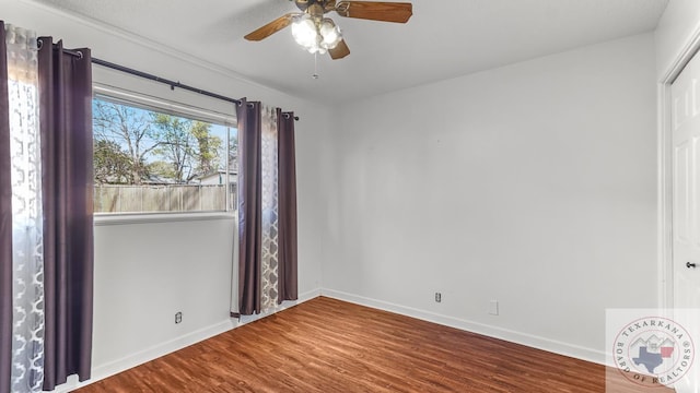 spare room with hardwood / wood-style flooring and ceiling fan