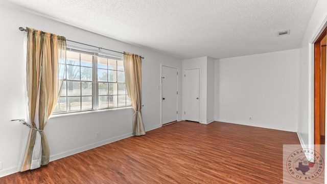 unfurnished bedroom featuring hardwood / wood-style floors and a textured ceiling