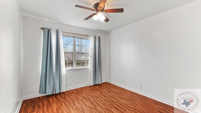 empty room with hardwood / wood-style flooring, ceiling fan, and a textured ceiling