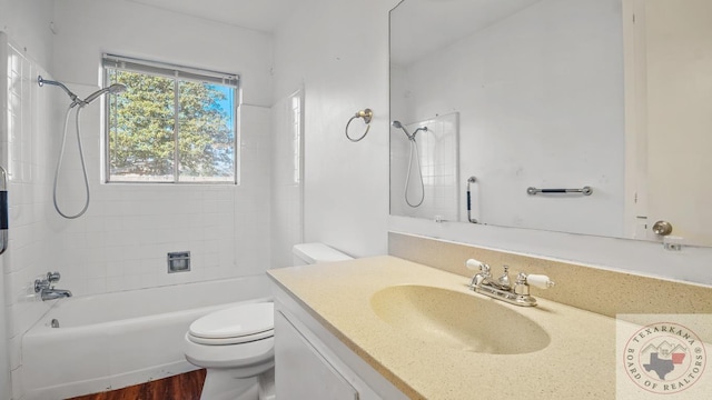 full bathroom featuring vanity, toilet, tiled shower / bath, and wood-type flooring