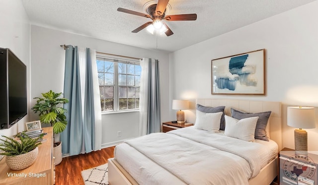 1208 Colorado St, Texarkana, TX 75503 - bedroom with a textured ceiling, wood finished floors, and a ceiling fan
