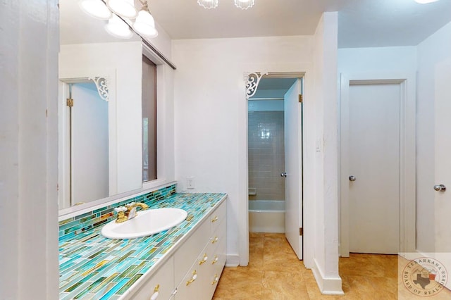 bathroom with vanity, tiled shower / bath, and tile patterned flooring