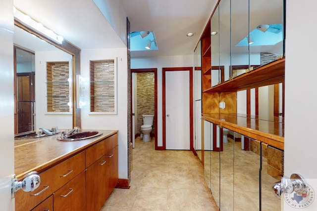 bathroom featuring toilet and vanity