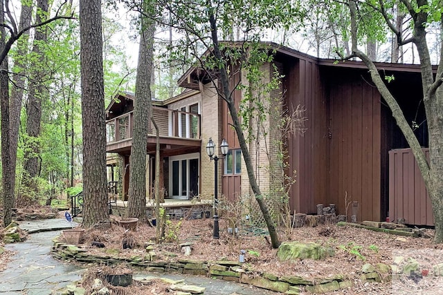 view of side of property with a balcony