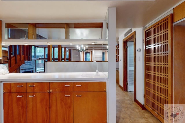 kitchen with sink and a chandelier