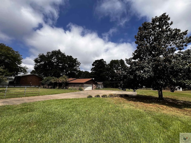 view of front of property with a garage and a front lawn