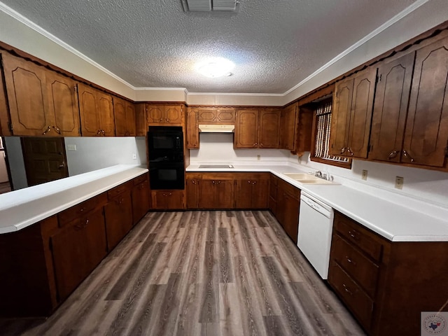 kitchen featuring sink, a textured ceiling, black appliances, and crown molding